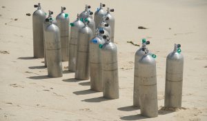 aluminum scuba tanks on beach