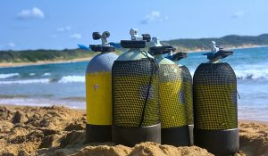 steel scuba tanks on beach